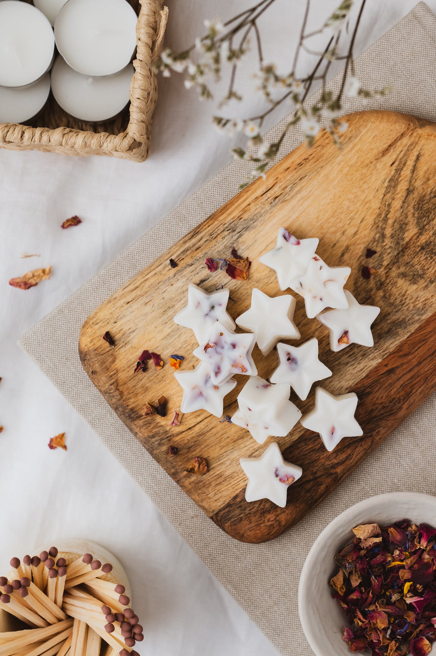 Star-shaped Midnight Berries scented wax melts on a chopping board