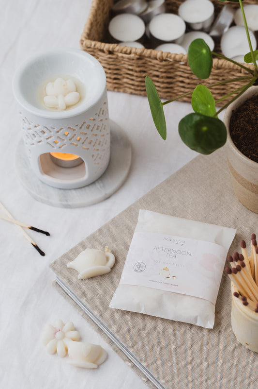 The picture depicts our Afternoon Tea Wax Melts Melting in a Wax Burner