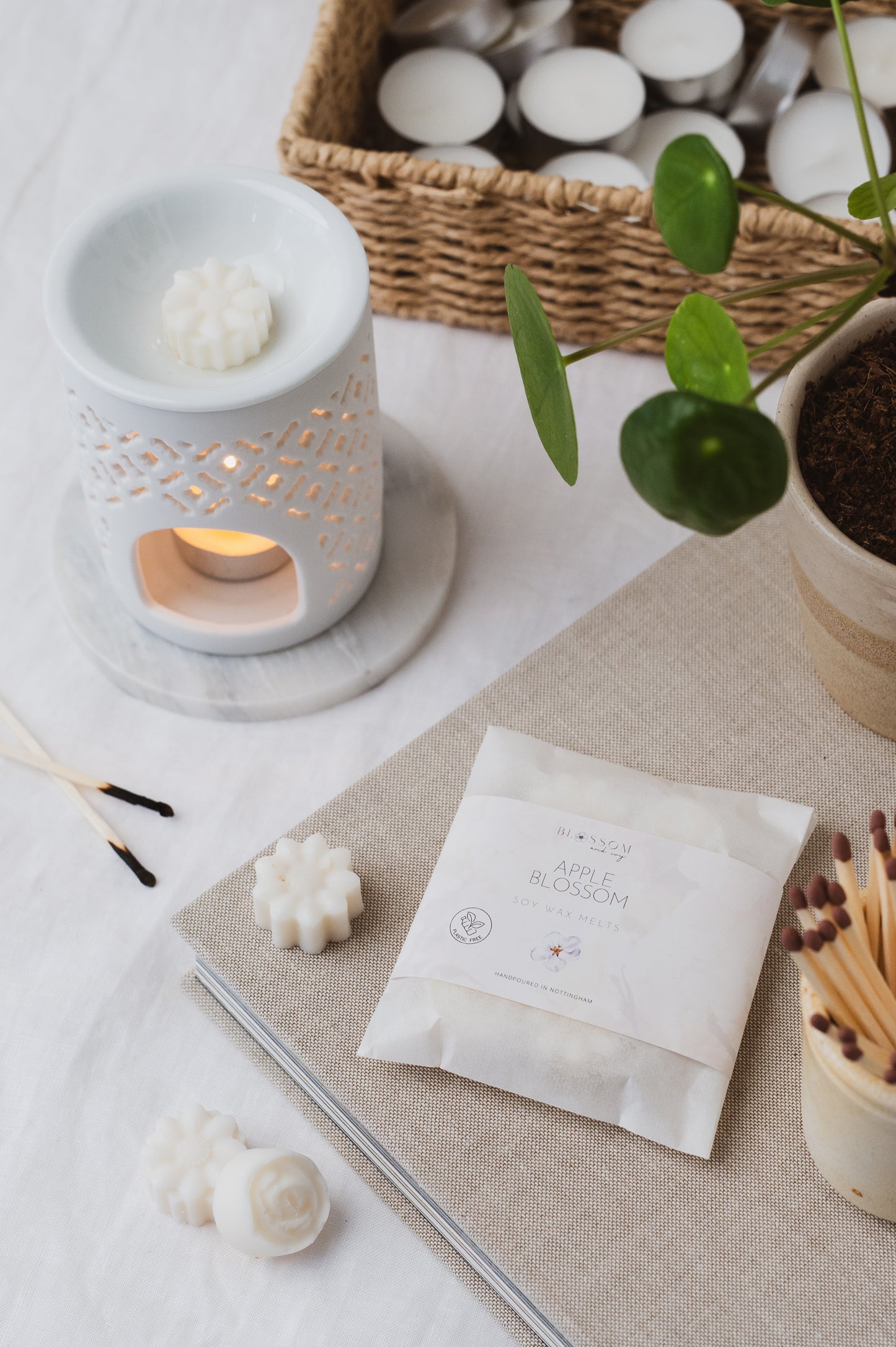 The picture depicts our Apple Blossom botanical soy wax melts melting in a wax burner.