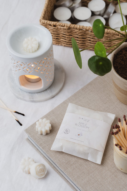 The picture depicts our Apple Blossom botanical soy wax melts melting in a wax burner.