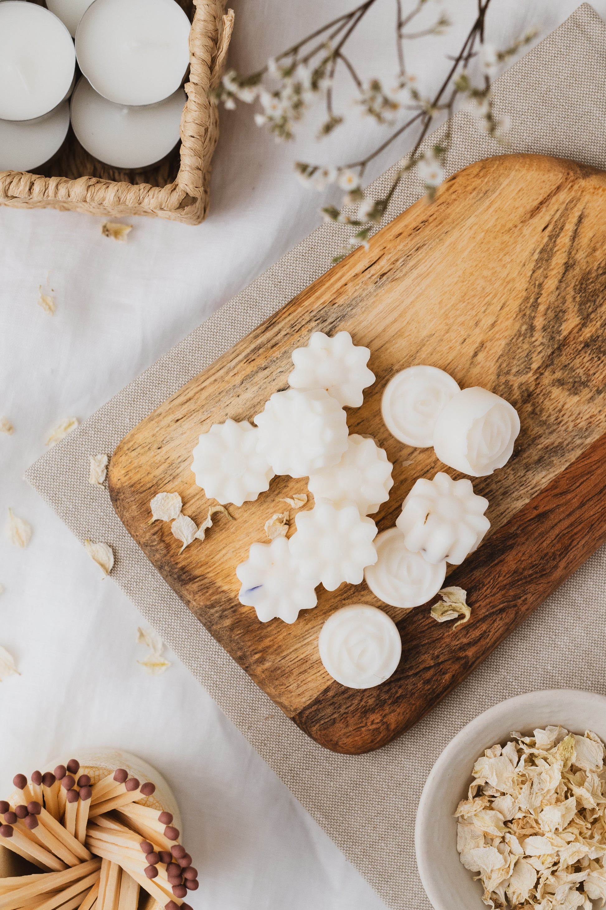 Our Apple Blossom botanical soy wax melts laid-out onto a chopping board.