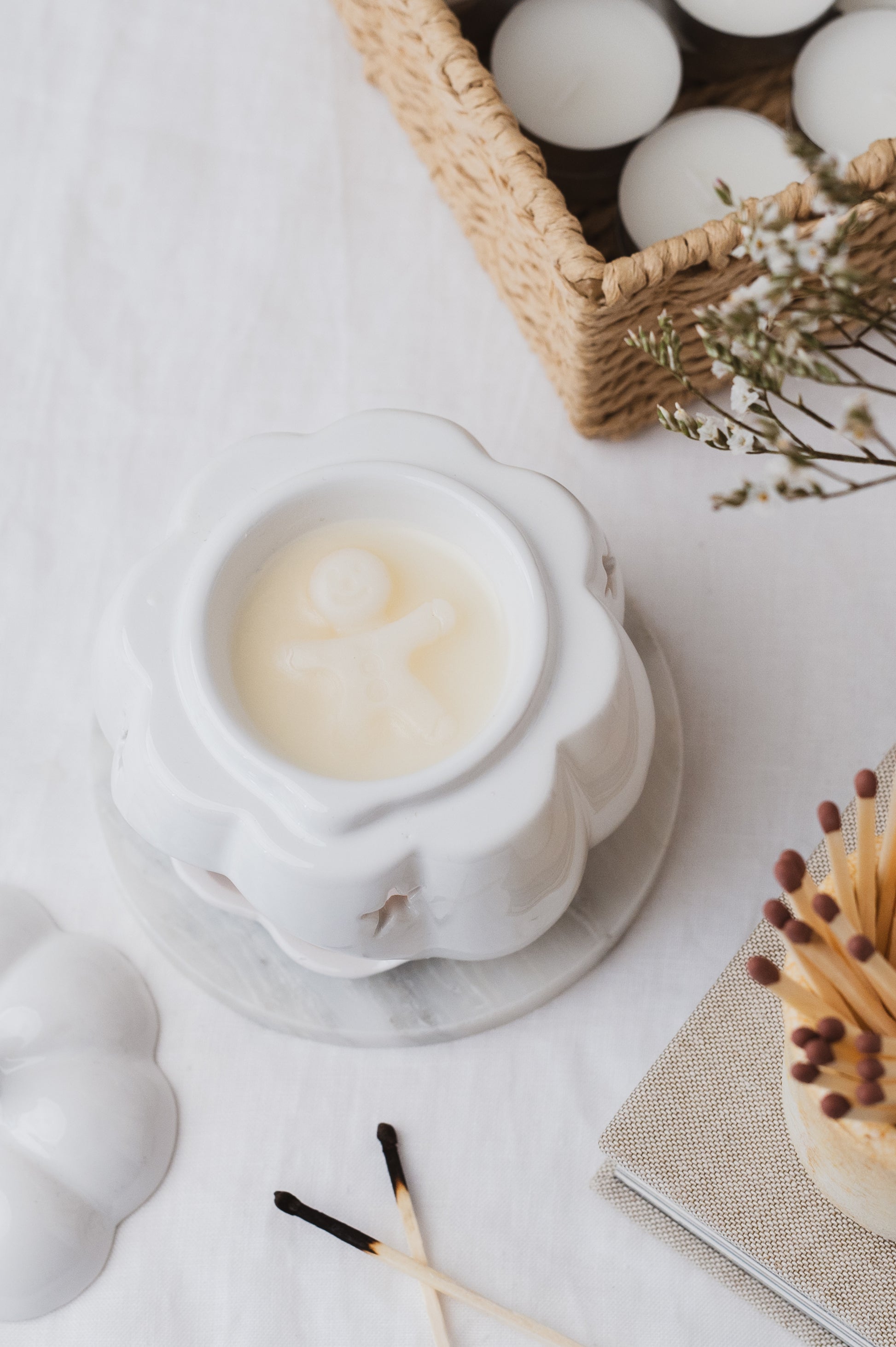 Gingerbread-shaped soy wax melt melting in a wax burner.