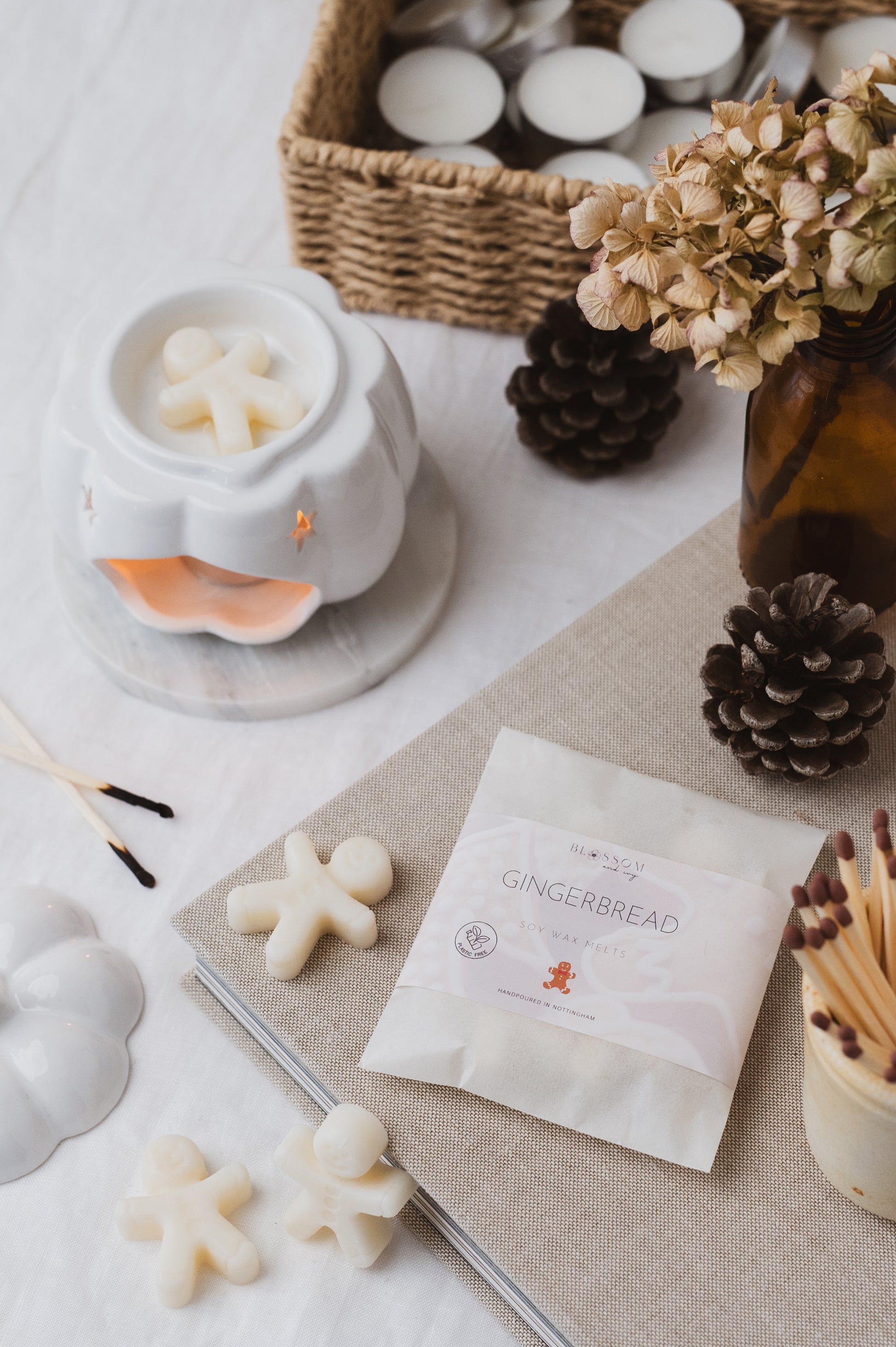 Gingerbread shaped soy wax melt bag resting on a book.